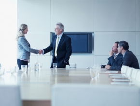 Die Flexibilität und Unabhängigkeit des Interim-Managers eröffnen oft neue Perspektiven. Manager und Managerin schütteln in Besprechung Hände, © iStockbygetty/Martin Barraud